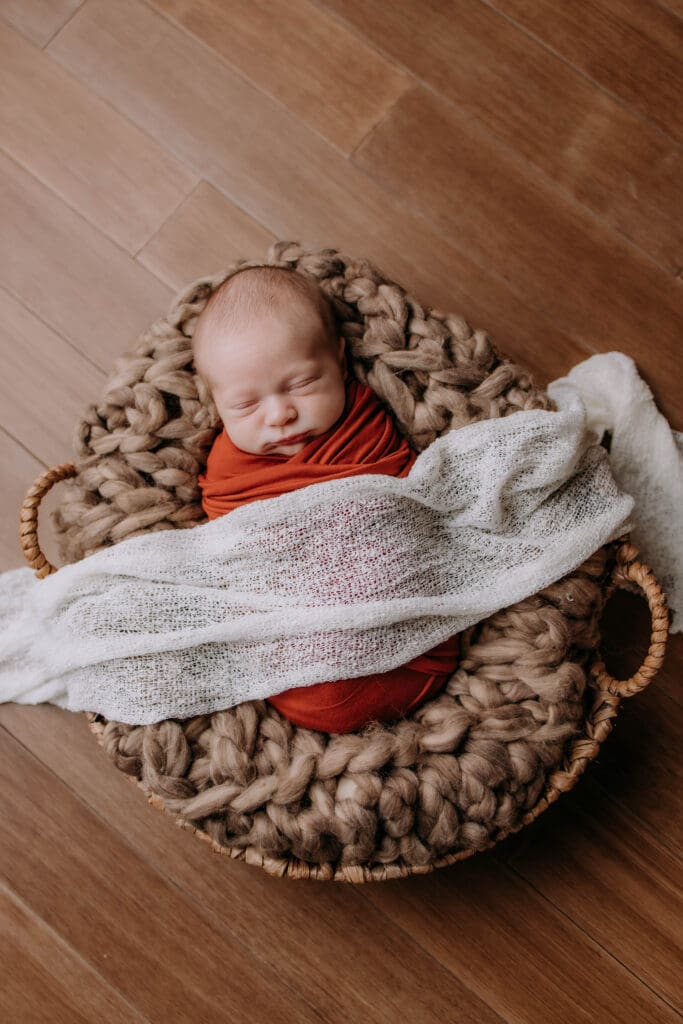newborn wrapped in basket for newborn photography in Nashville
