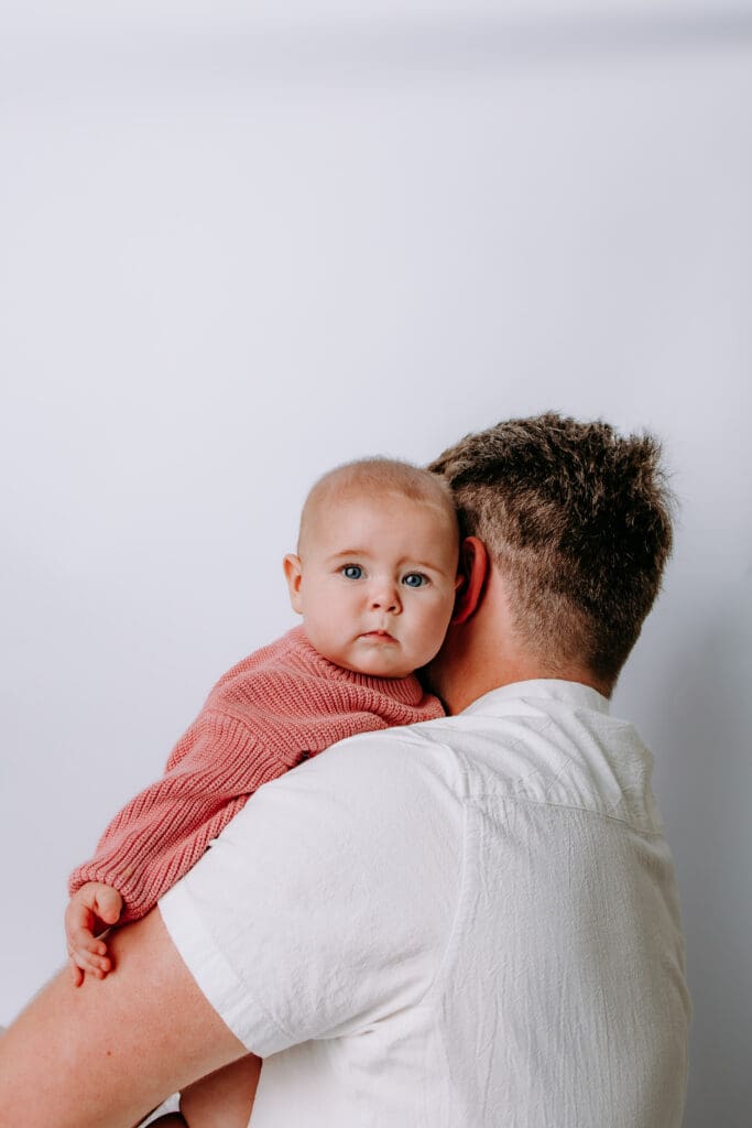 6 month baby with parents and studio backdrop for Gallatin, TN milestone photoshoot