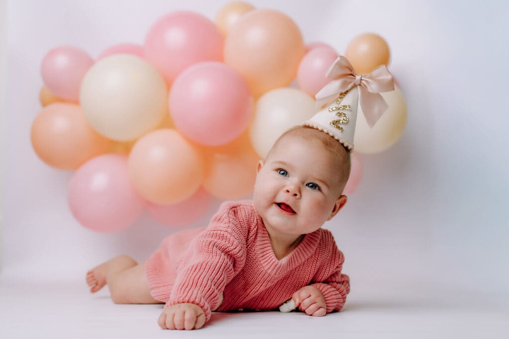 6 month baby laying down with decorations for Lebanon, TN milestone photoshoot