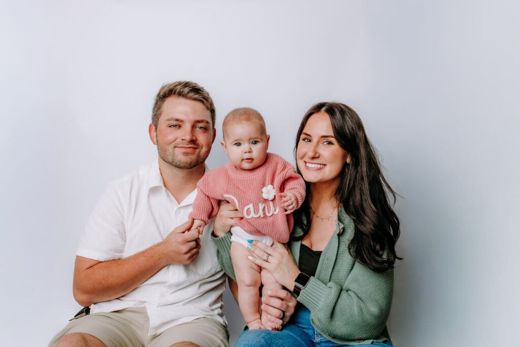 6 month baby with parents and studio backdrop for Nashville, TN milestone photoshoot