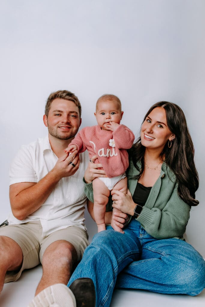 6 month baby with parents and studio backdrop for Mt. Juliet, TN milestone photoshoot