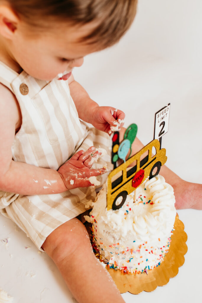 baby smashing birthday cake